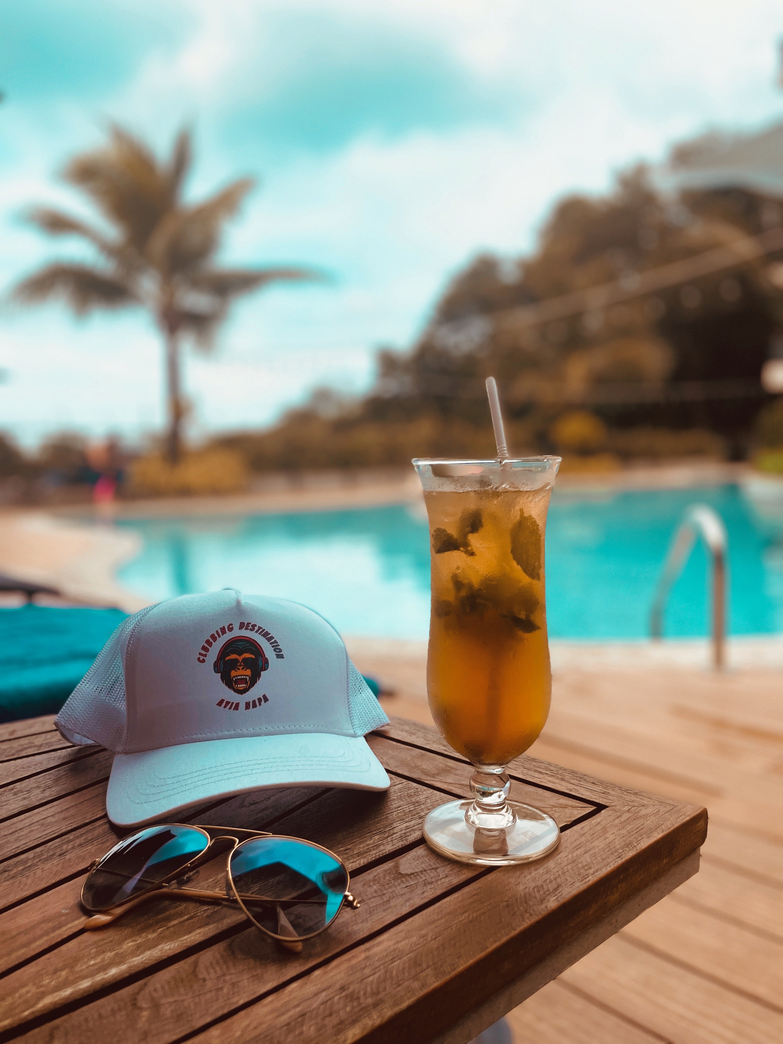 Hat of clubbing destination with a cocktail and sunglasses in Ayia Napa