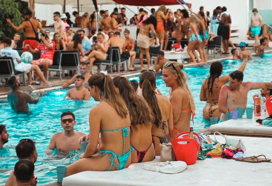 People sitting and having fun at sunset sessions pool party in Ayia Napa