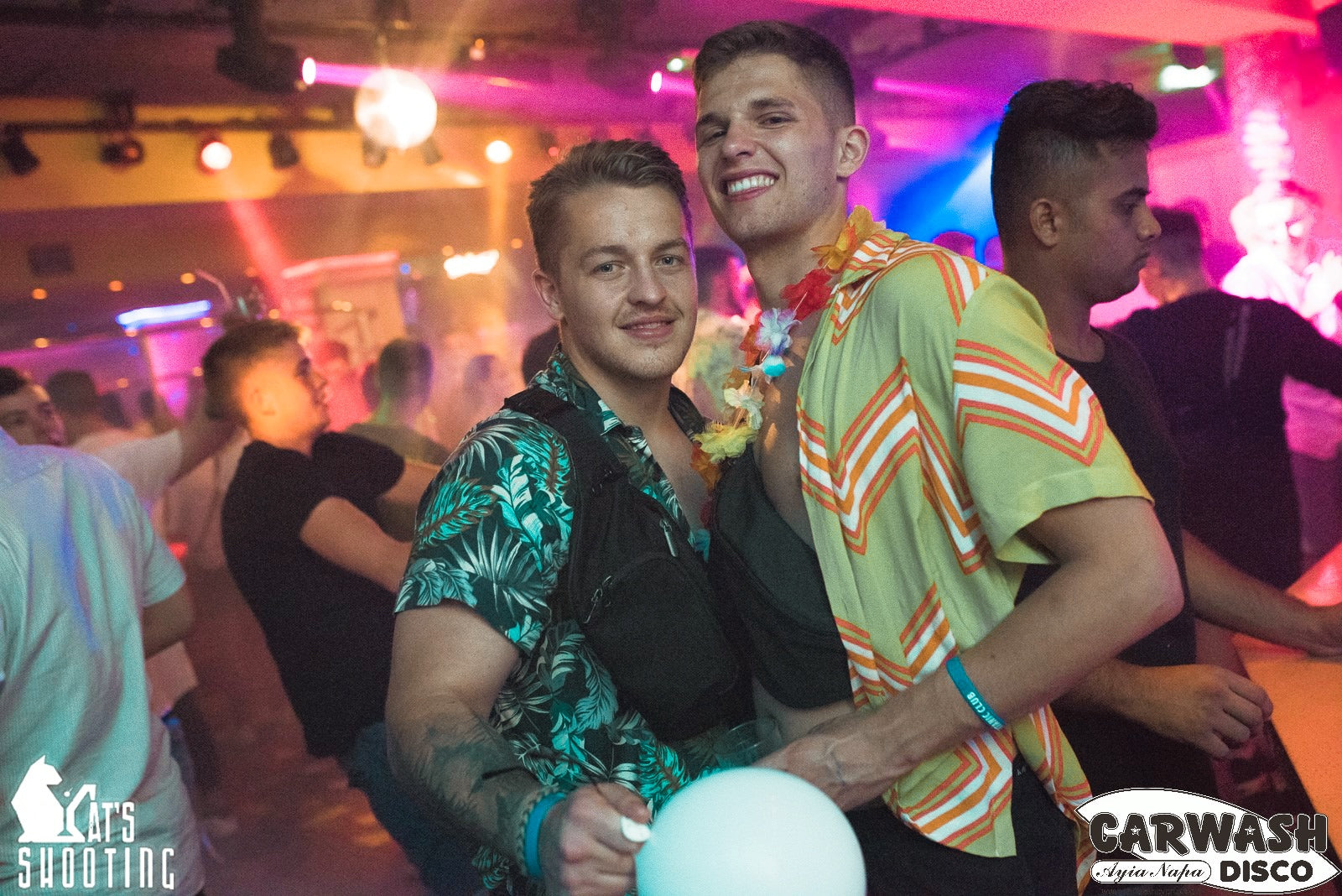 Boys having fun at carwash disco in ayia napa