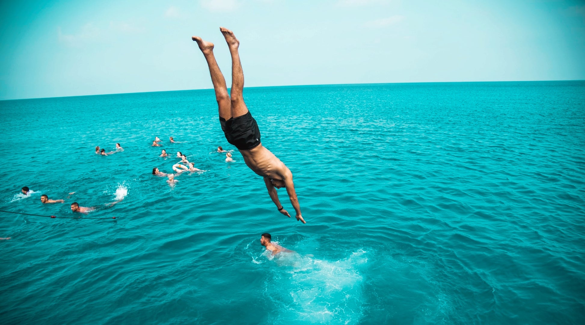 Boy jumping from the boat party in Ayia Napa